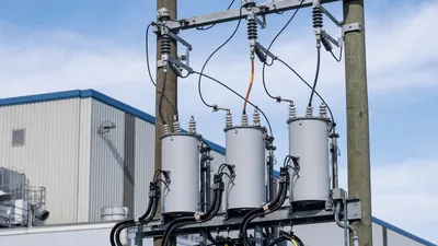 Pole mounted 3 phase high leg delta transformer installation showing high voltage bushings and secondary wiring