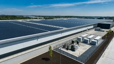 Rooftop commercial solar panels installed on an industrial manufacturing facility with an energy storage system.