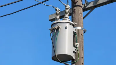 Pole-mounted single phase power transformer installed on utility distribution line