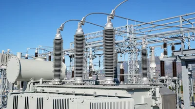 High voltage transformer bushing installed on an electrical power transformer tank
