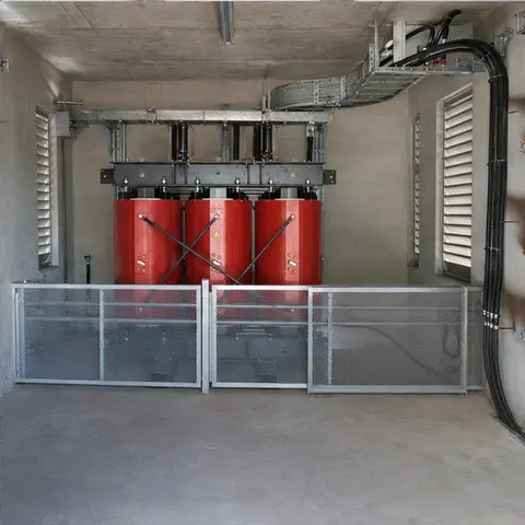Cast-resin dry-type transformer installed in a barriered and ventilated indoor transformer room